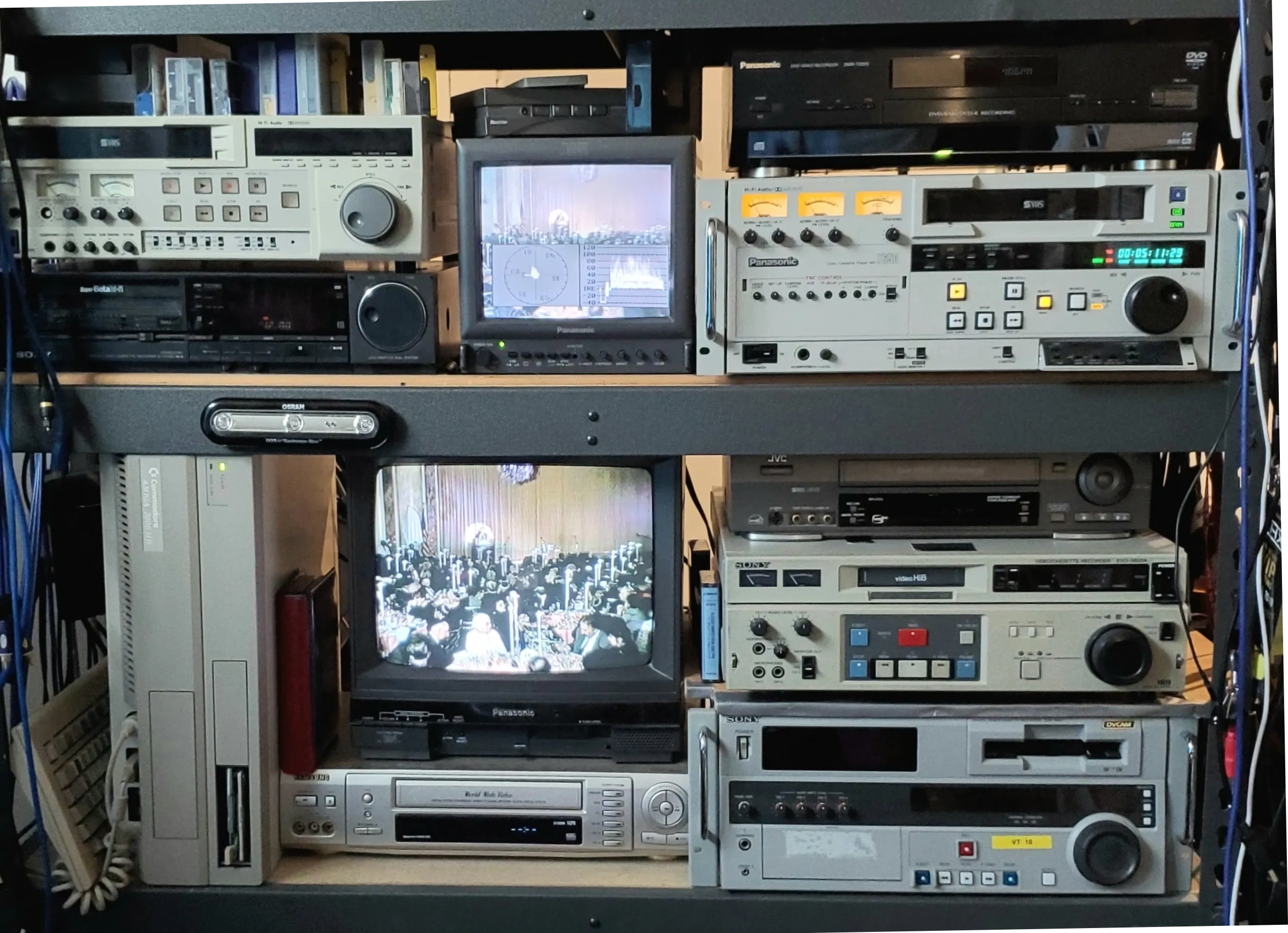 Vintage video equipment and monitors displaying old footage.
